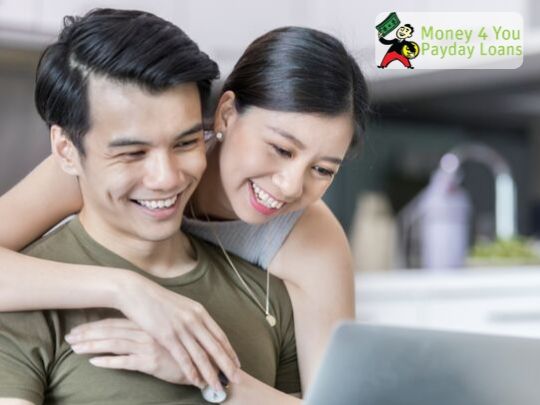 Happy Couple on a Laptop - Ways to get out of Debt